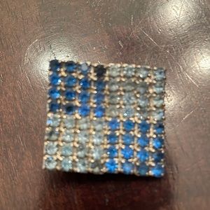 Vintage silver toned blue rhinestone pin. Good vintage condition.